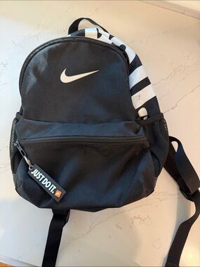 Small Nike Black Backpack with White Swoosh and Stripe Accent